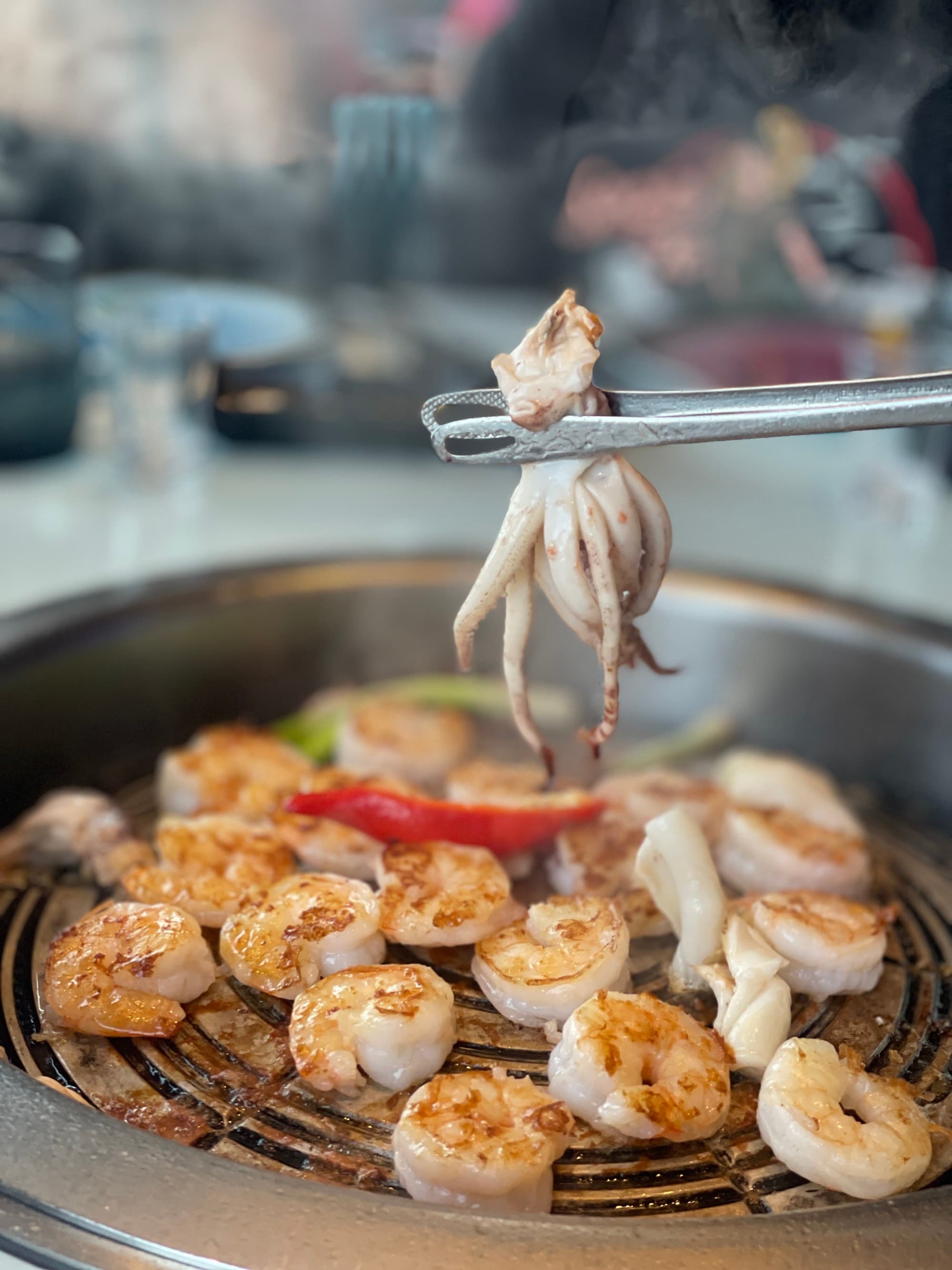 Seafood cooking on a grill.