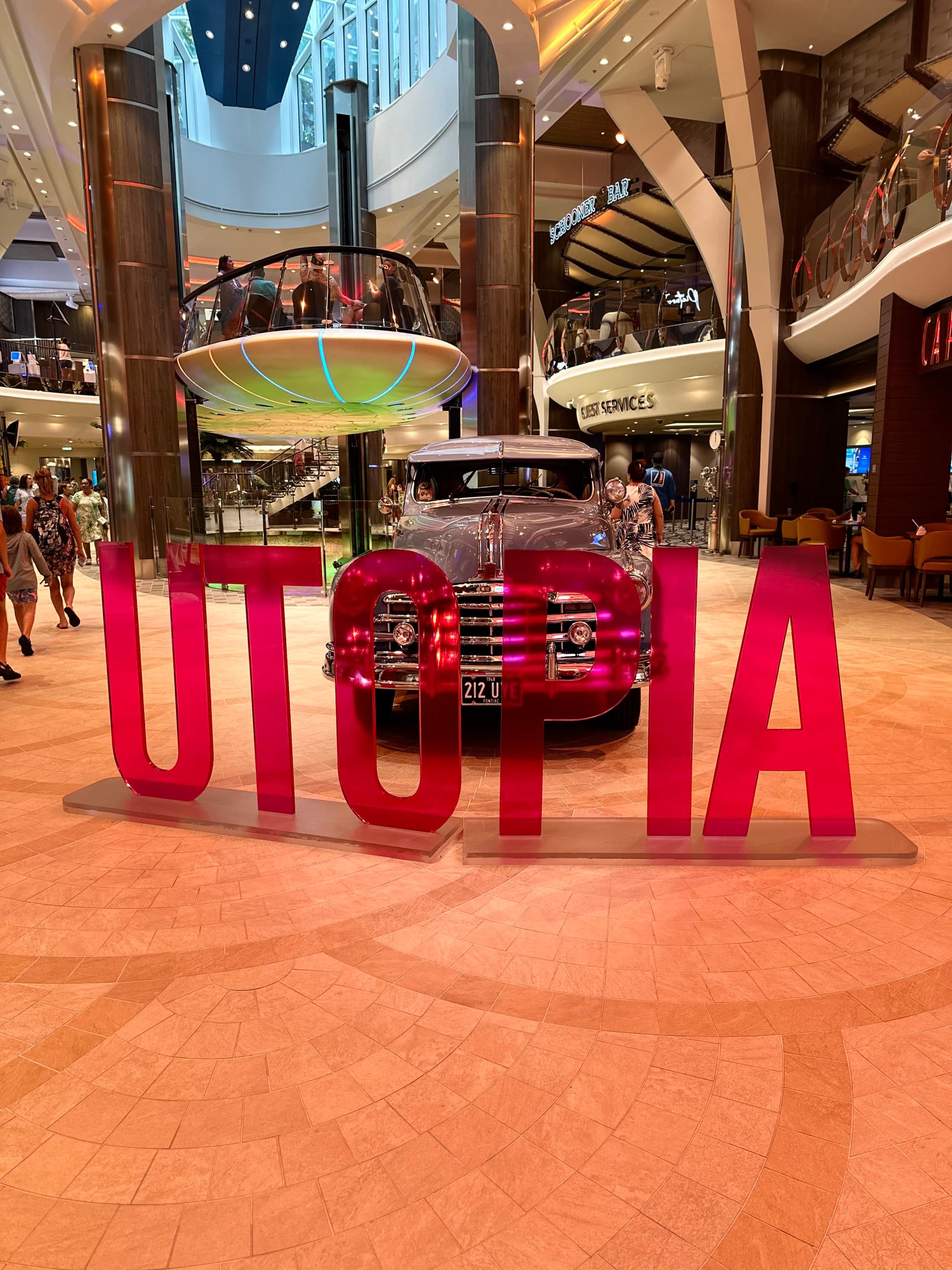 Large letters in red that read "Utopia" in the Utopia of the Seas Royal Promenade