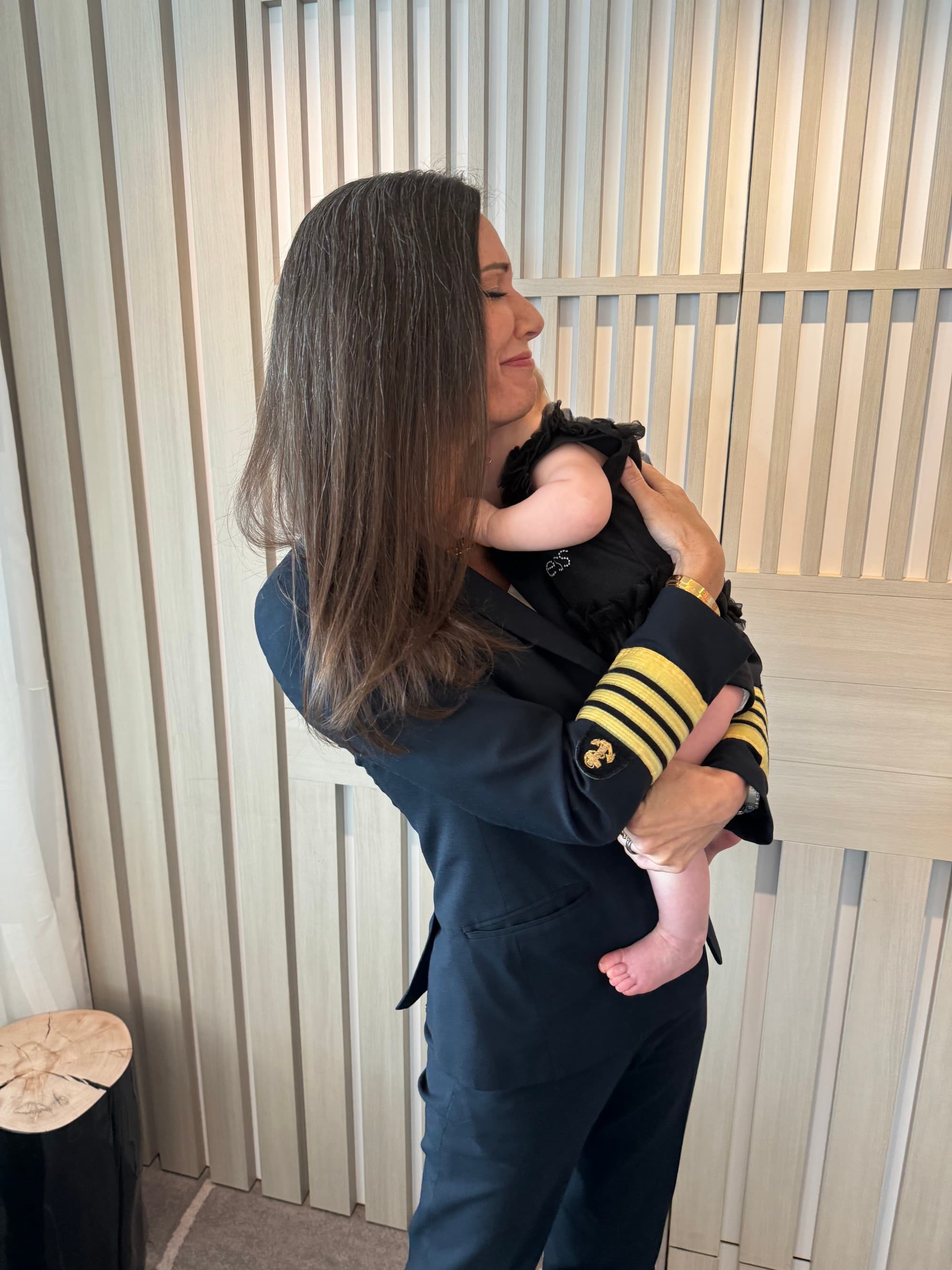 A ship captain holding a baby