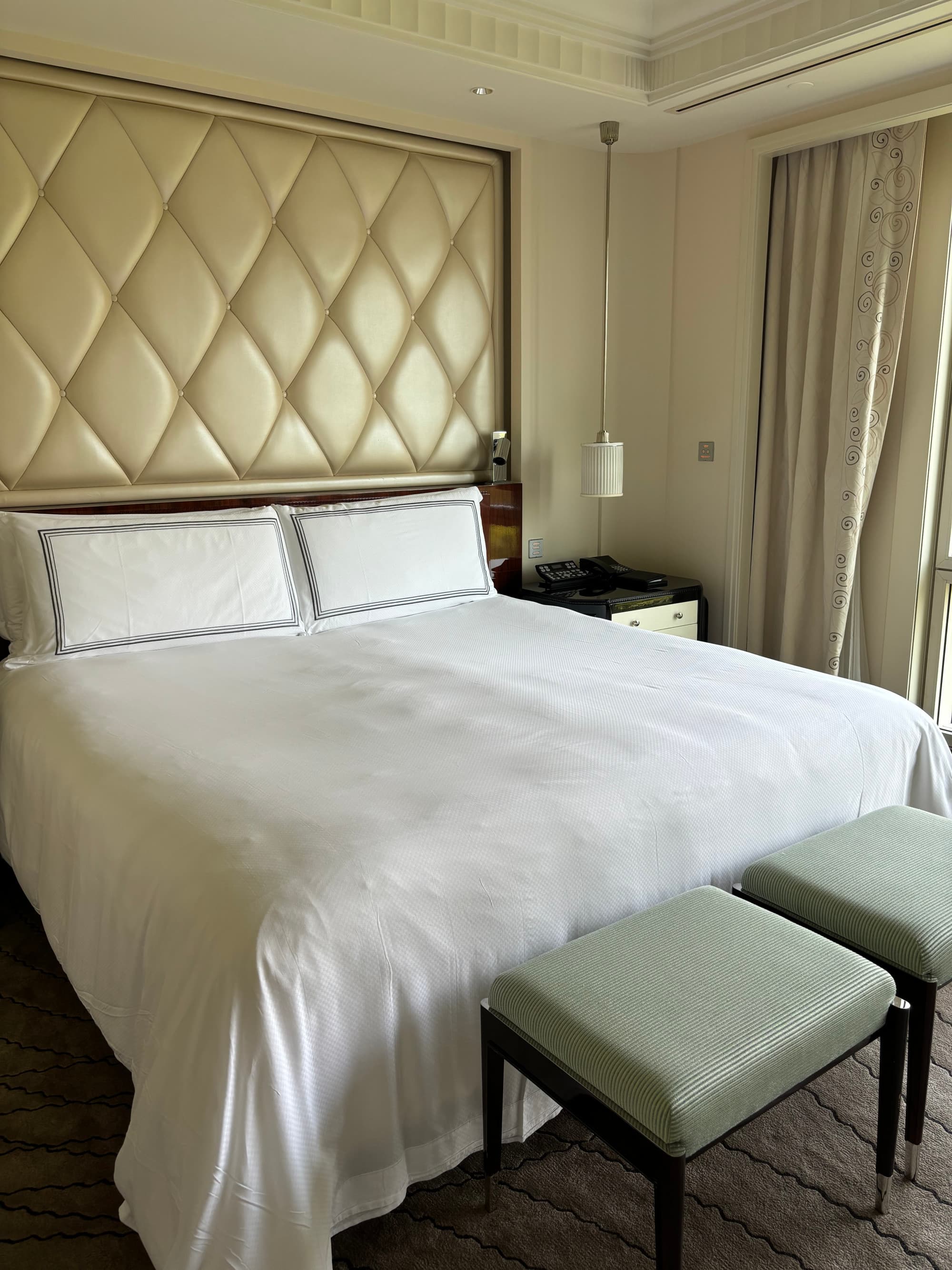 A white bed in a hotel room