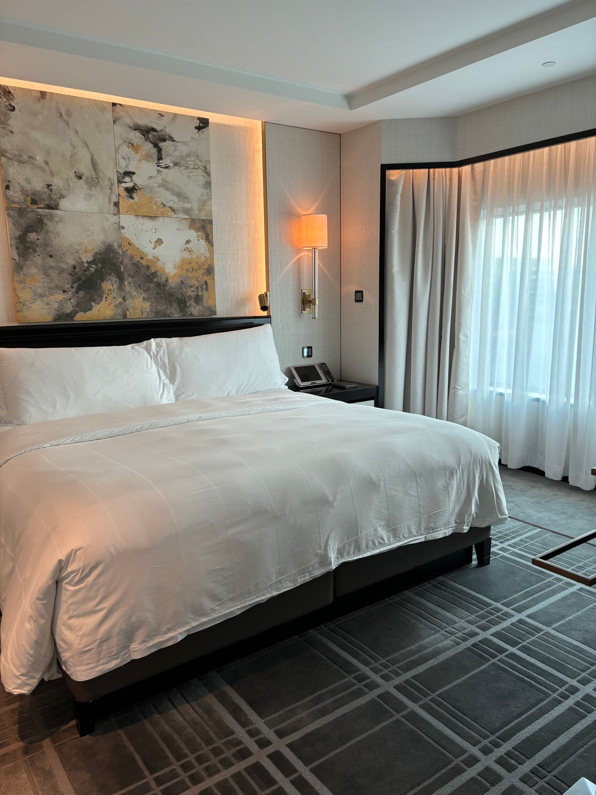 A large white bed in a hotel bedroom