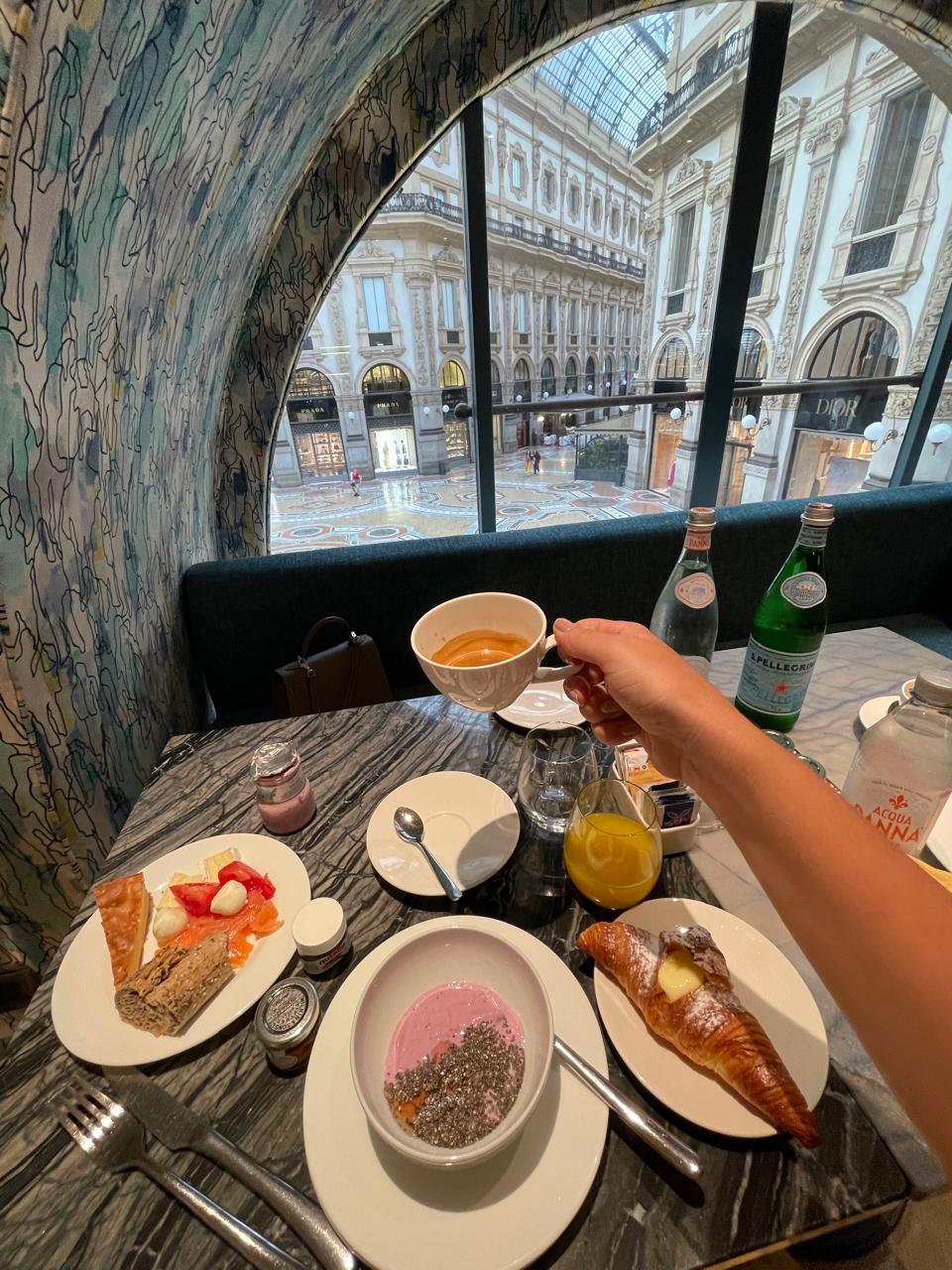 A table inside a restaurant with lots of plates of food on top