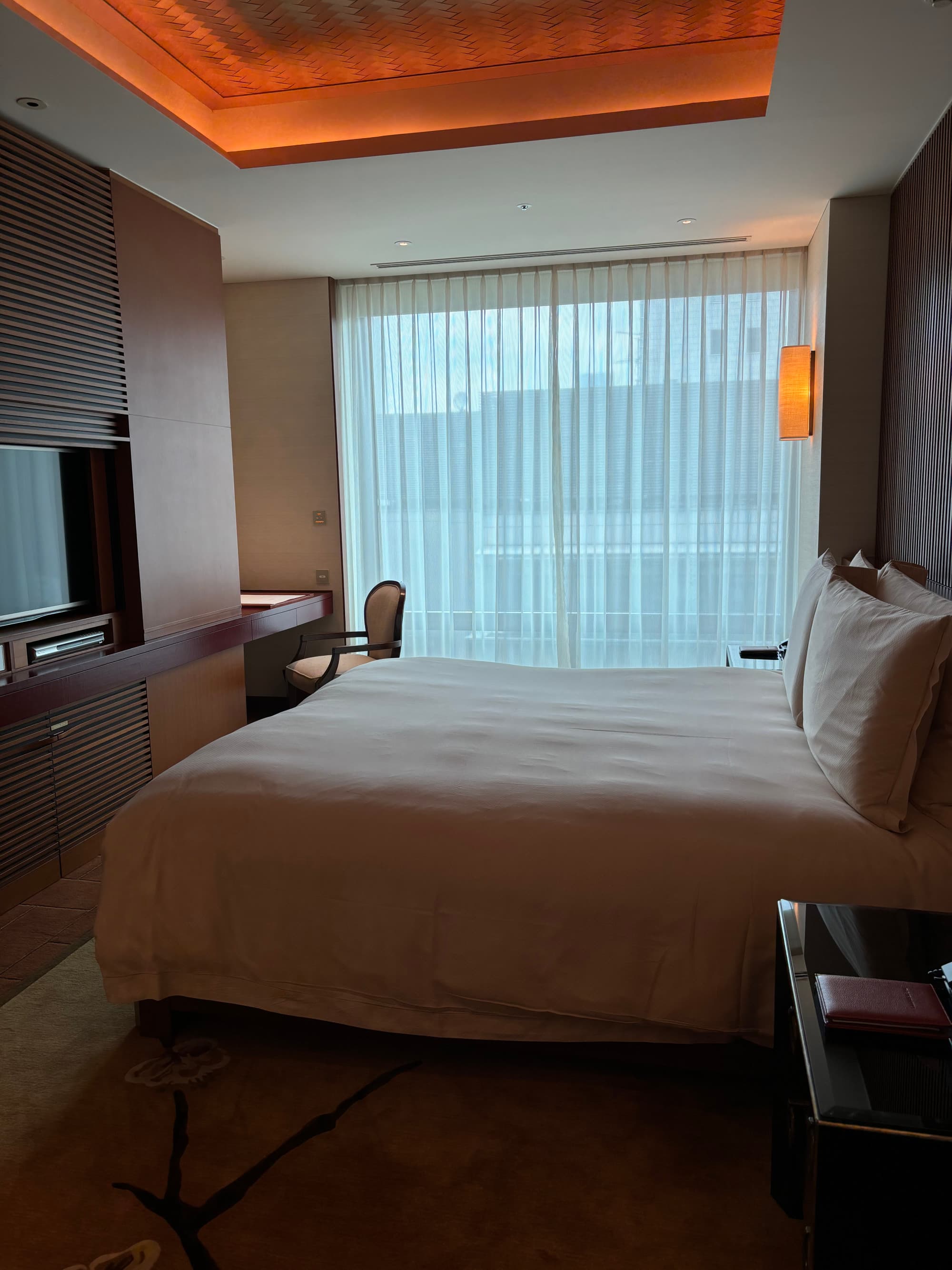 A large white bed in a hotel room