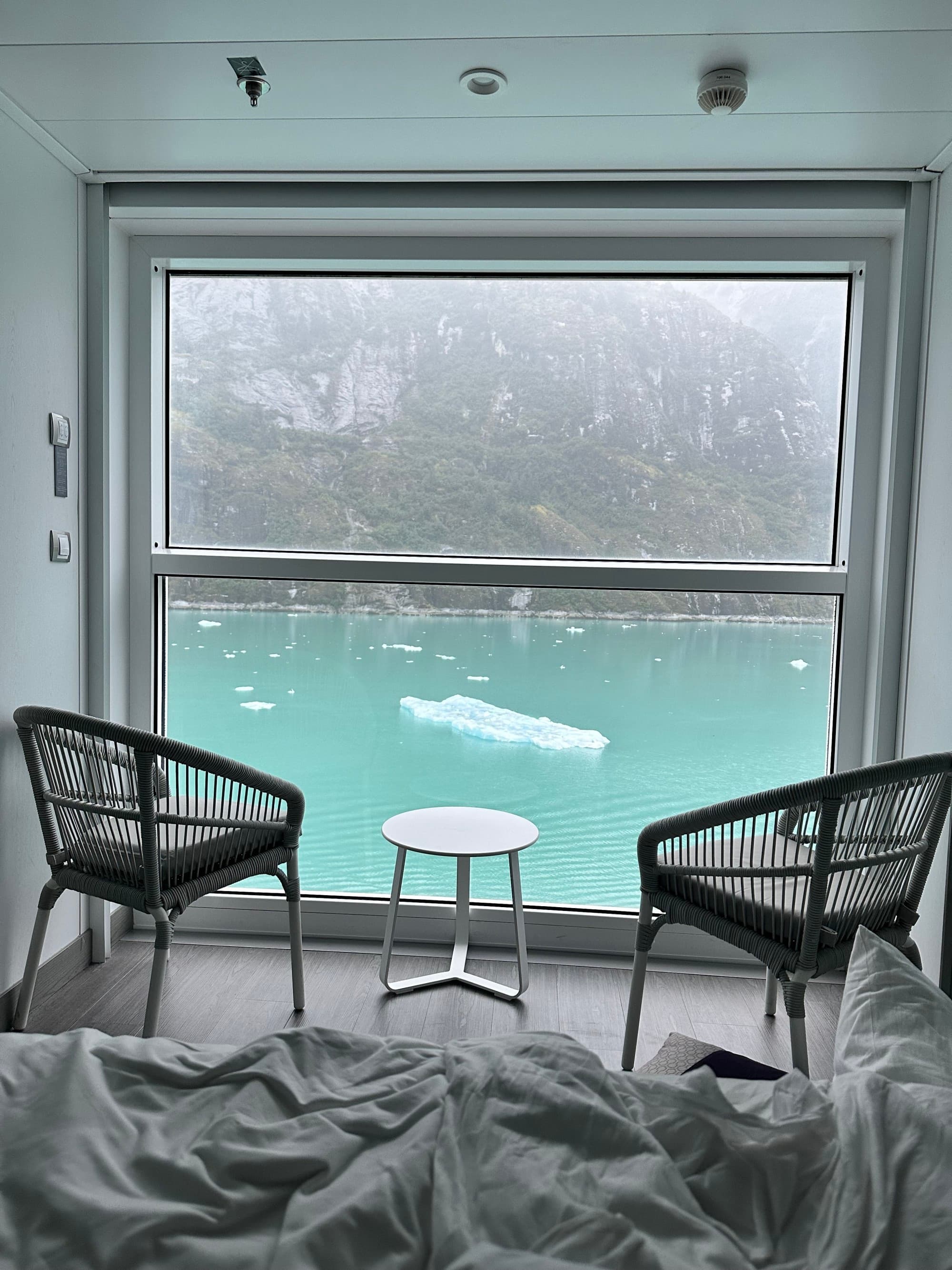 Two chairs in front of a floor-to-ceiling windows