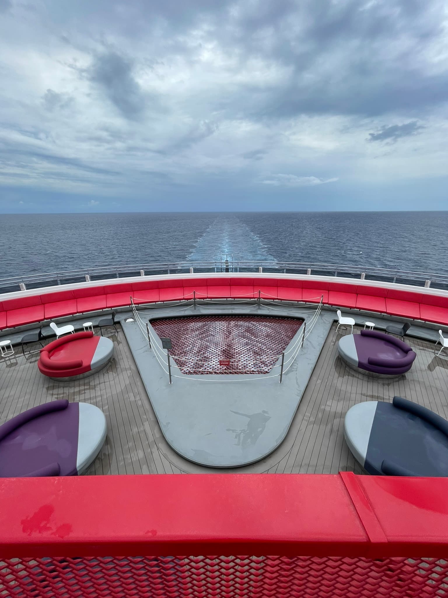 A view of the deck of the ship with the wake visible behind.