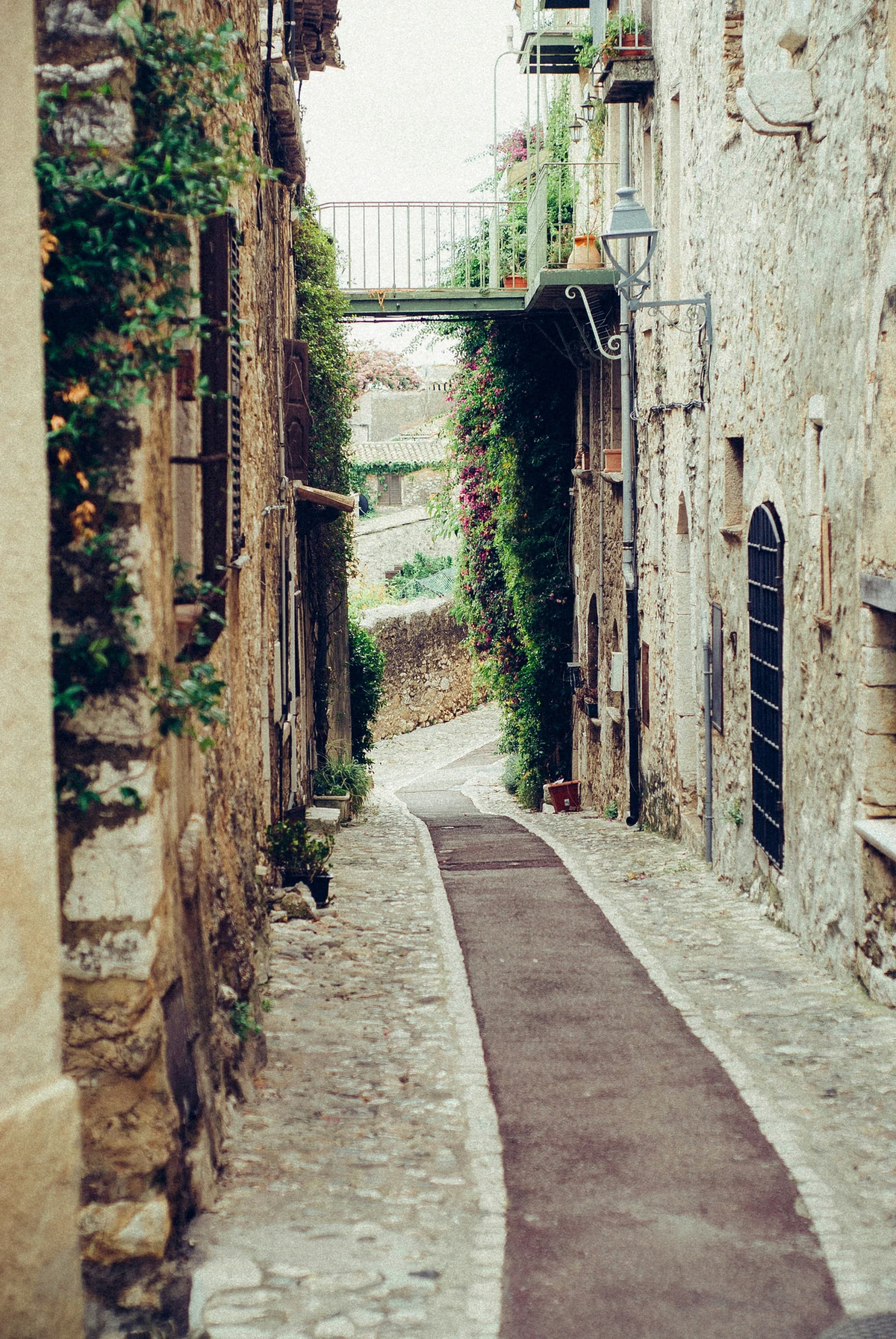 Narrow pathway surrounded by concrete buildings.