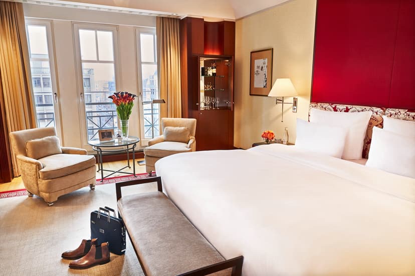 hotel room with a red wall and white bed