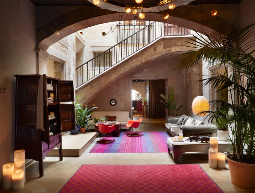 a stone staircase in a colorful lobby with red carpeting