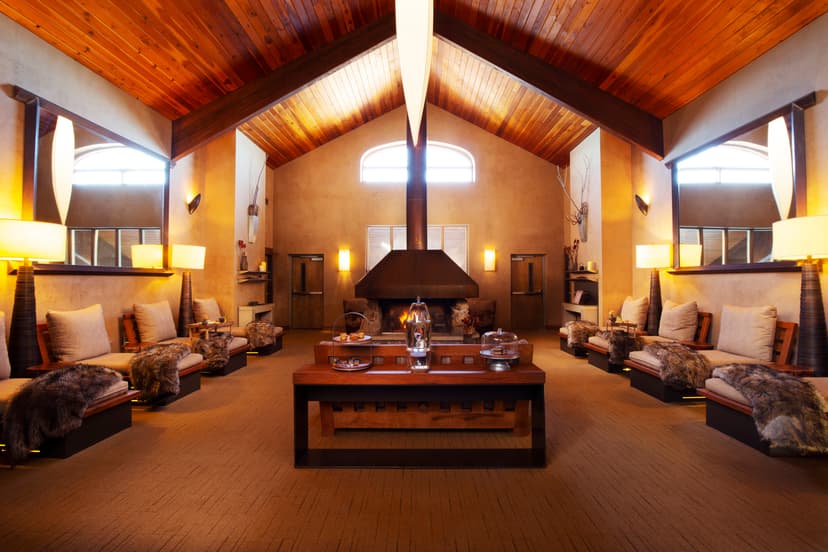 spa waiting area in a cozy lodge and chairs with fur blankets