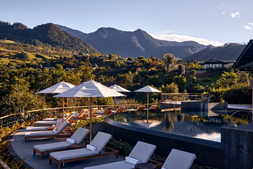 infinity pool amidst villas perched on a jungly mountain