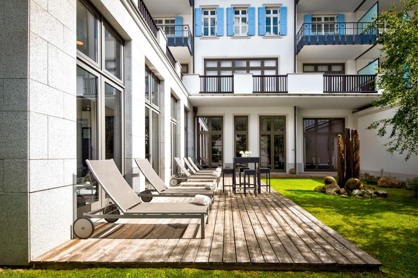 wooden deck with lounge chairs in a courtyard