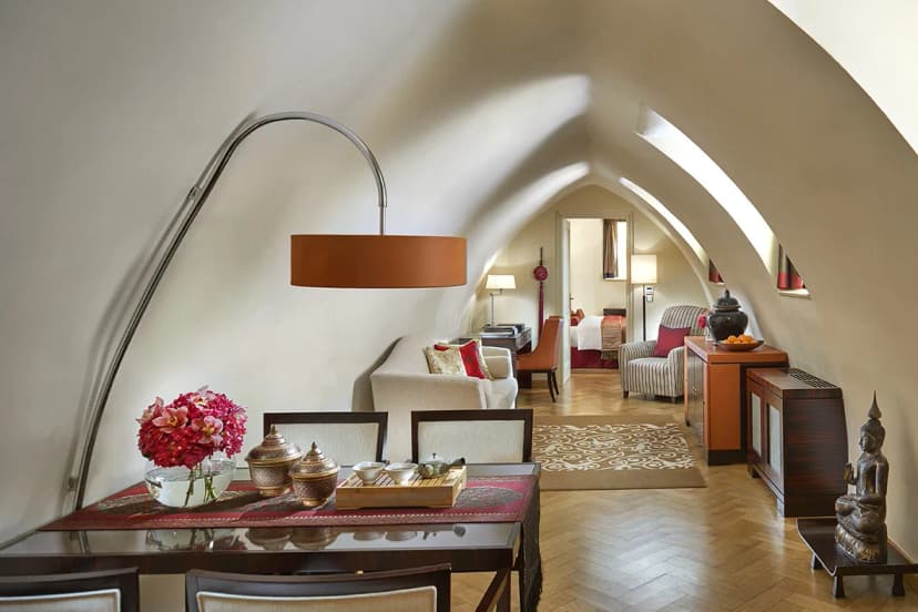 a cozy hotel room with a statue of the buddha sitting on the floor