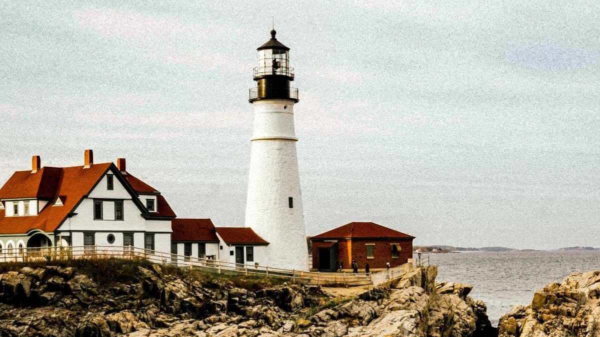 White lighthouse atop a cliffside