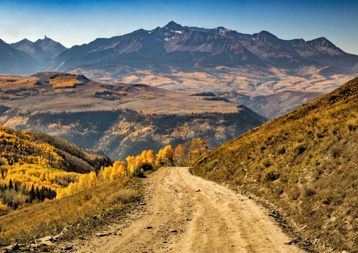 Dirt road with a view of mountains during the day