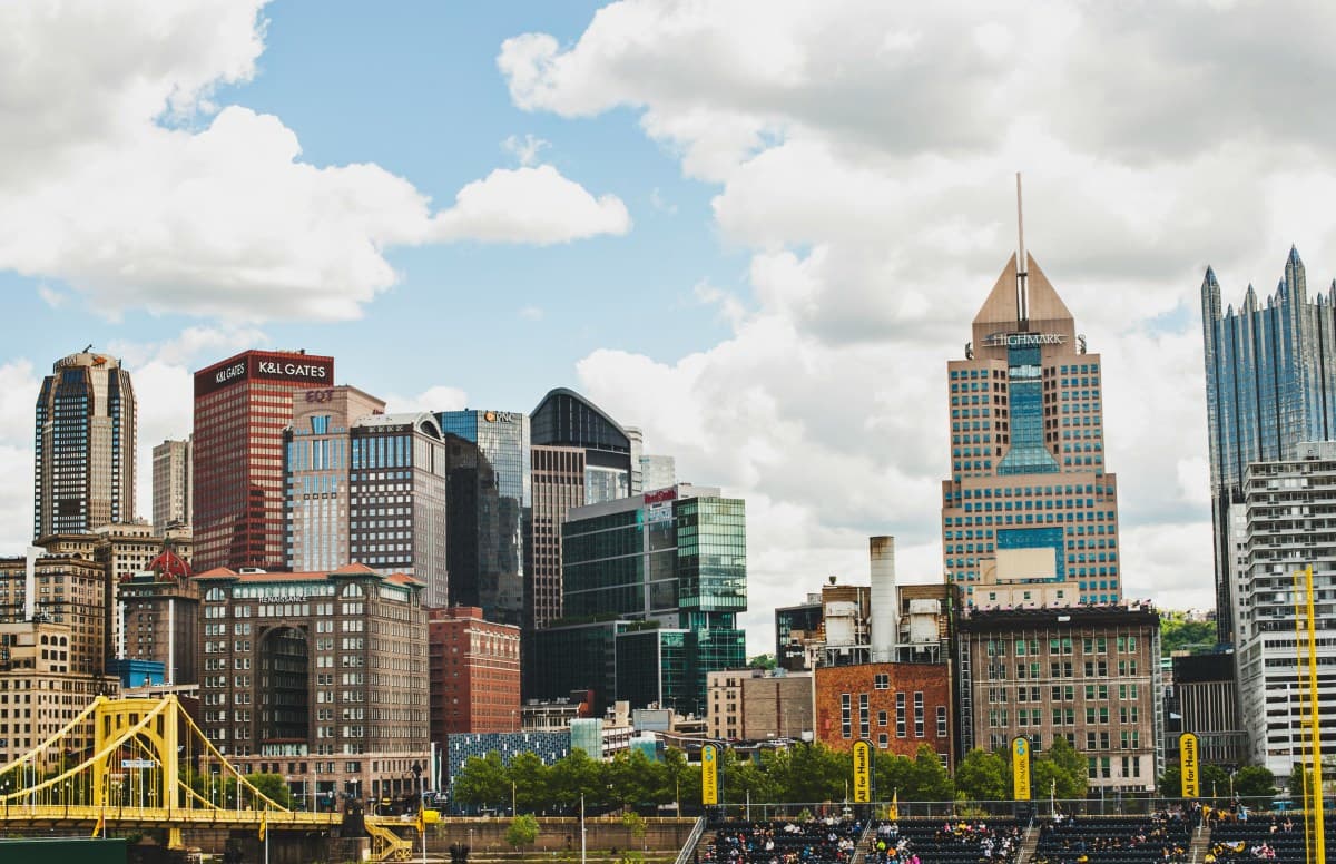 City buildings under white clouds during the daytime