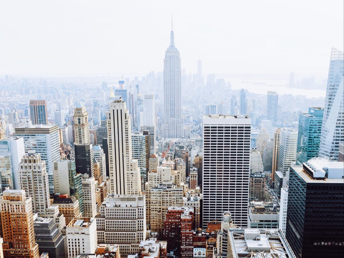 New York city skyline on a somewhat cloudy day with the Empire State building in the background.