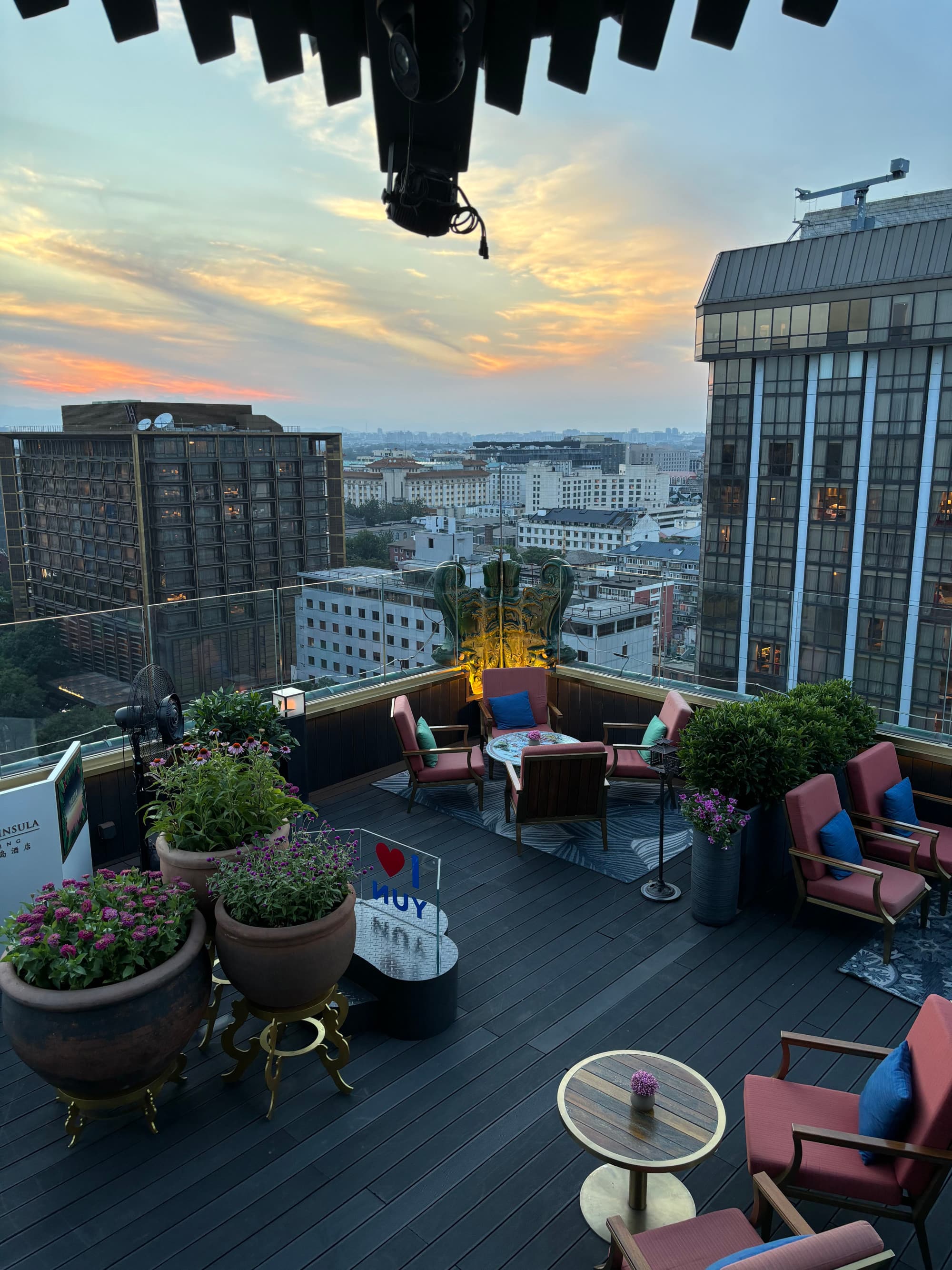 Aerial view of a rooftop patio with a seating area of red charis