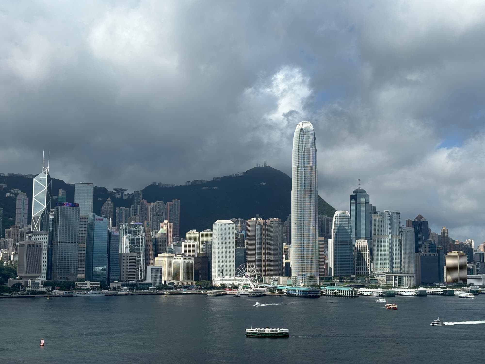 Tall, city buildings next to a body of water during the daytie