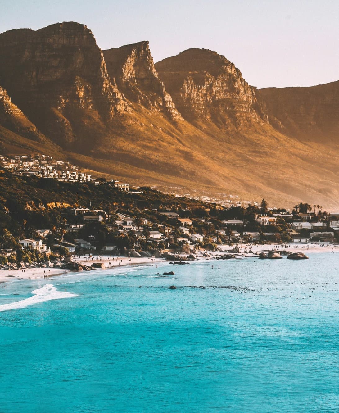 Blue bay with a city and mountains in the background in South Africa.