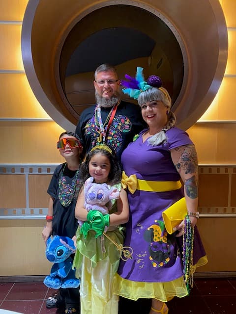 Advisor posing onboard the Disney Family Cruise in a well-lit hallway.