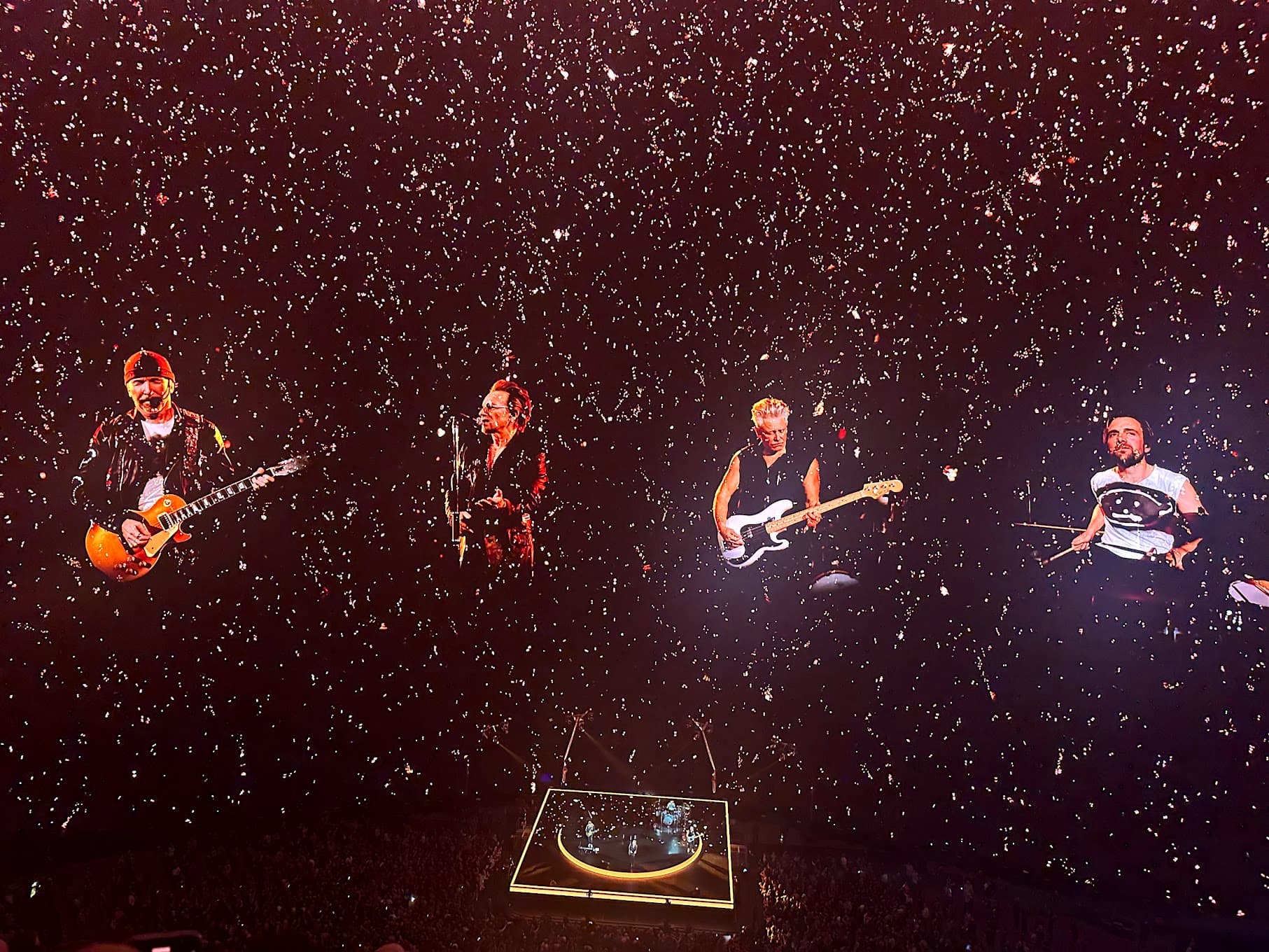 A view of U2 performing in Las Vegas against a starry black background