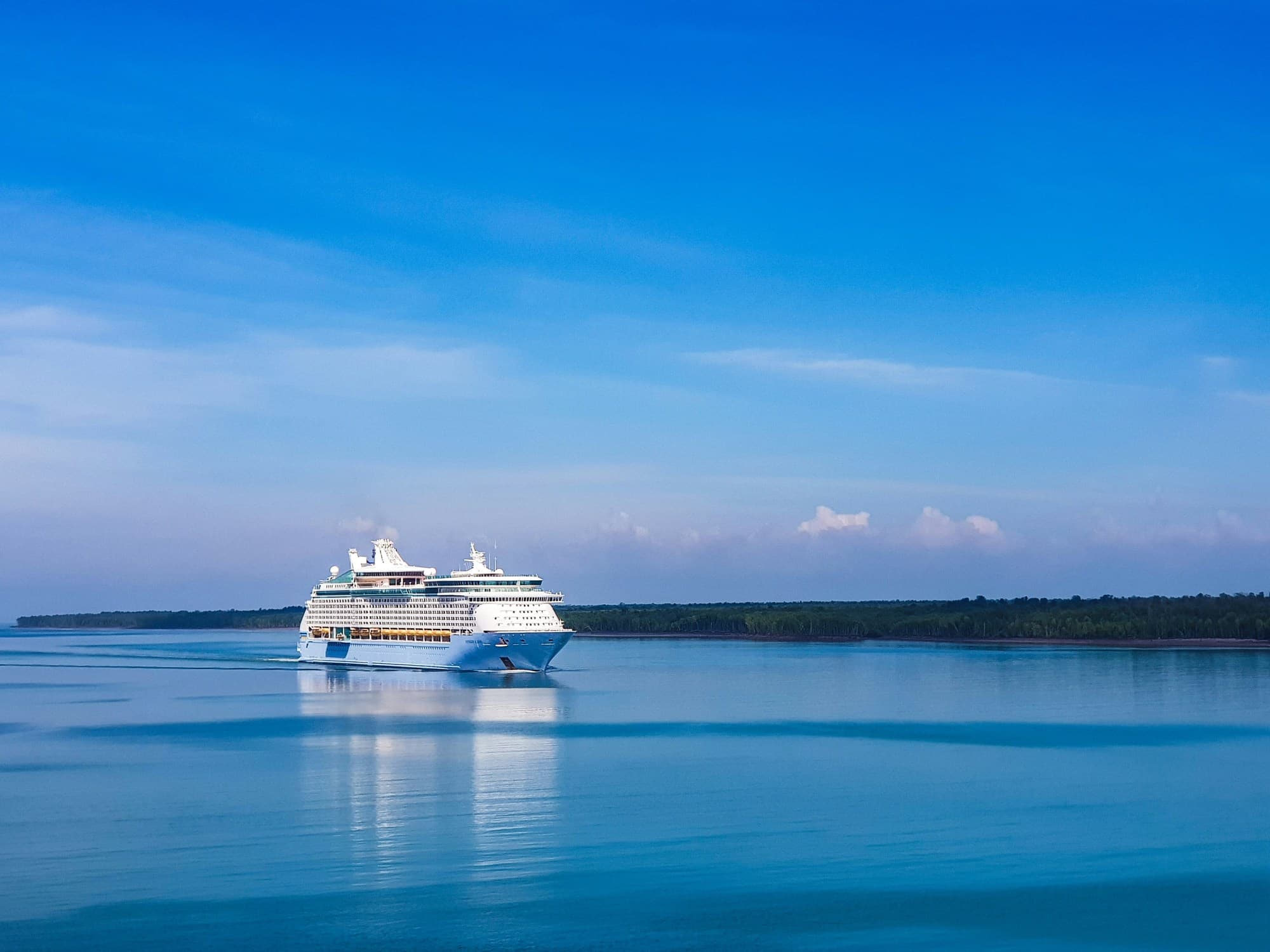 A large, white cruise ship on the water during the daytime