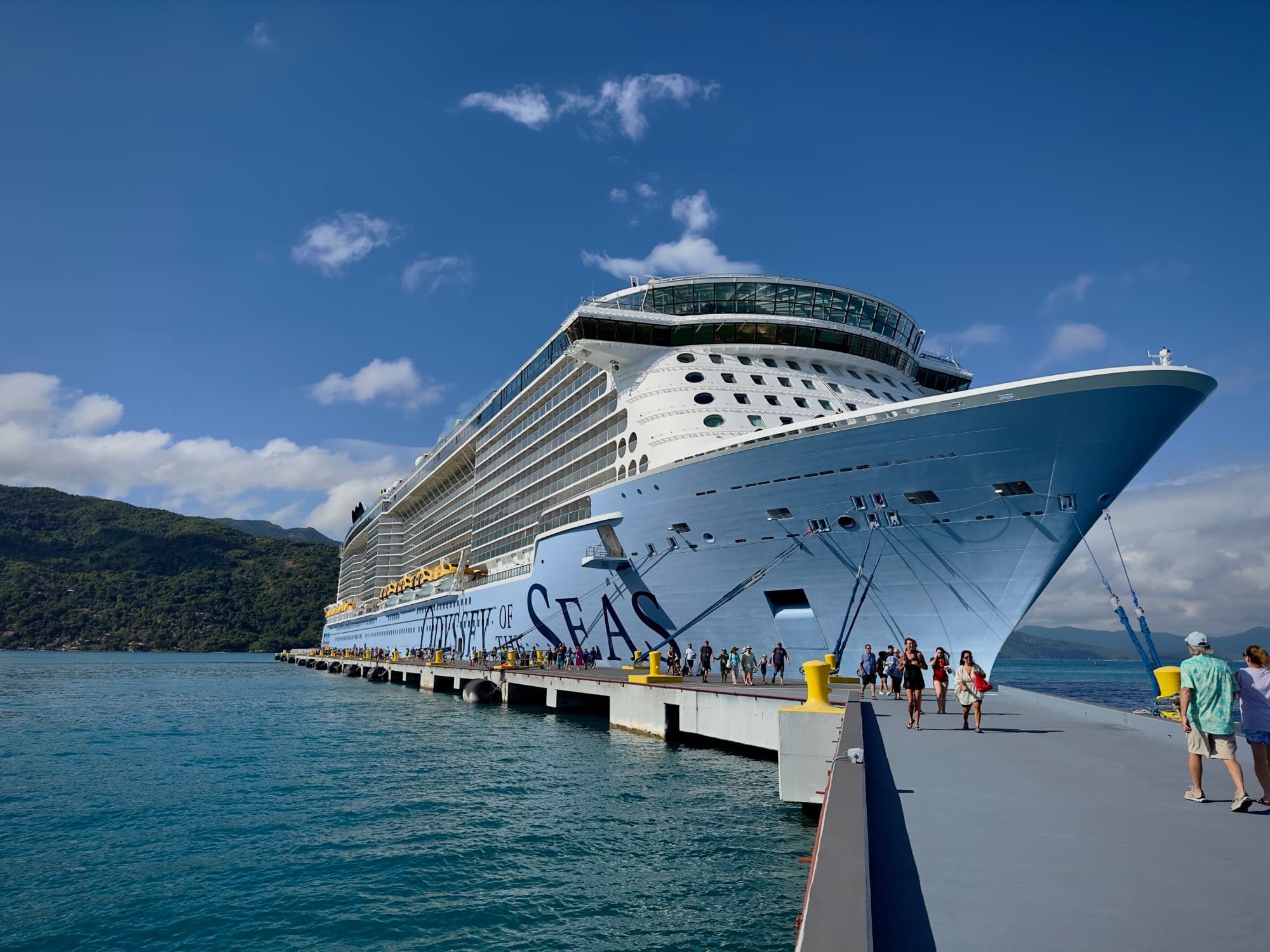 A large cruise ship docked at a port in the water