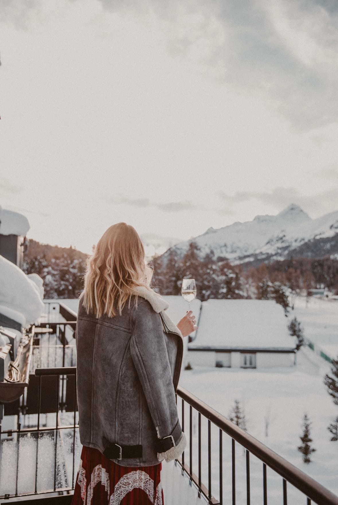 back of the girl staring at the scenery on a winter ski trip