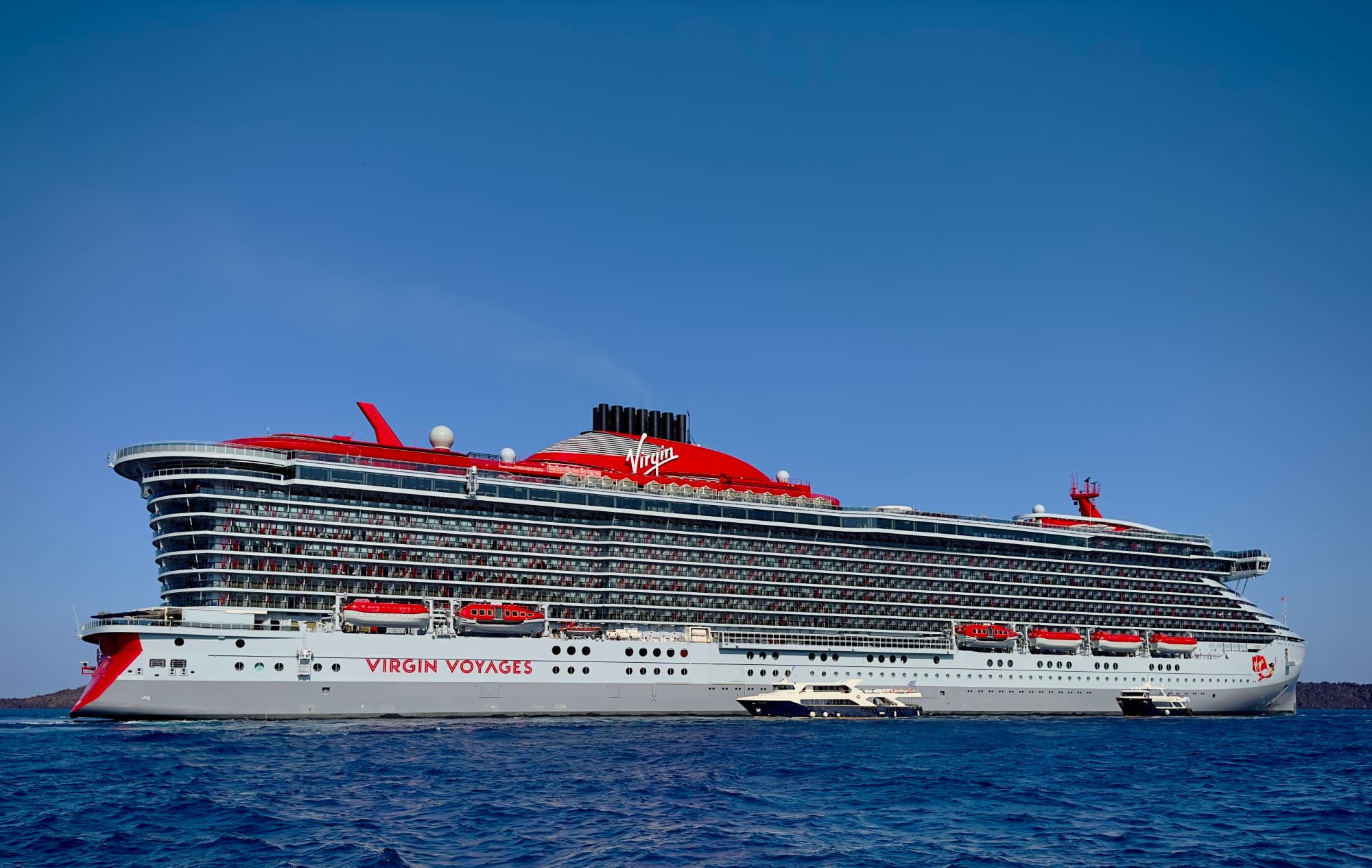 White and red cruise ship in the water