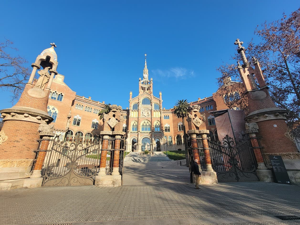 A low-angled photo of a large, orange cathedral-like building