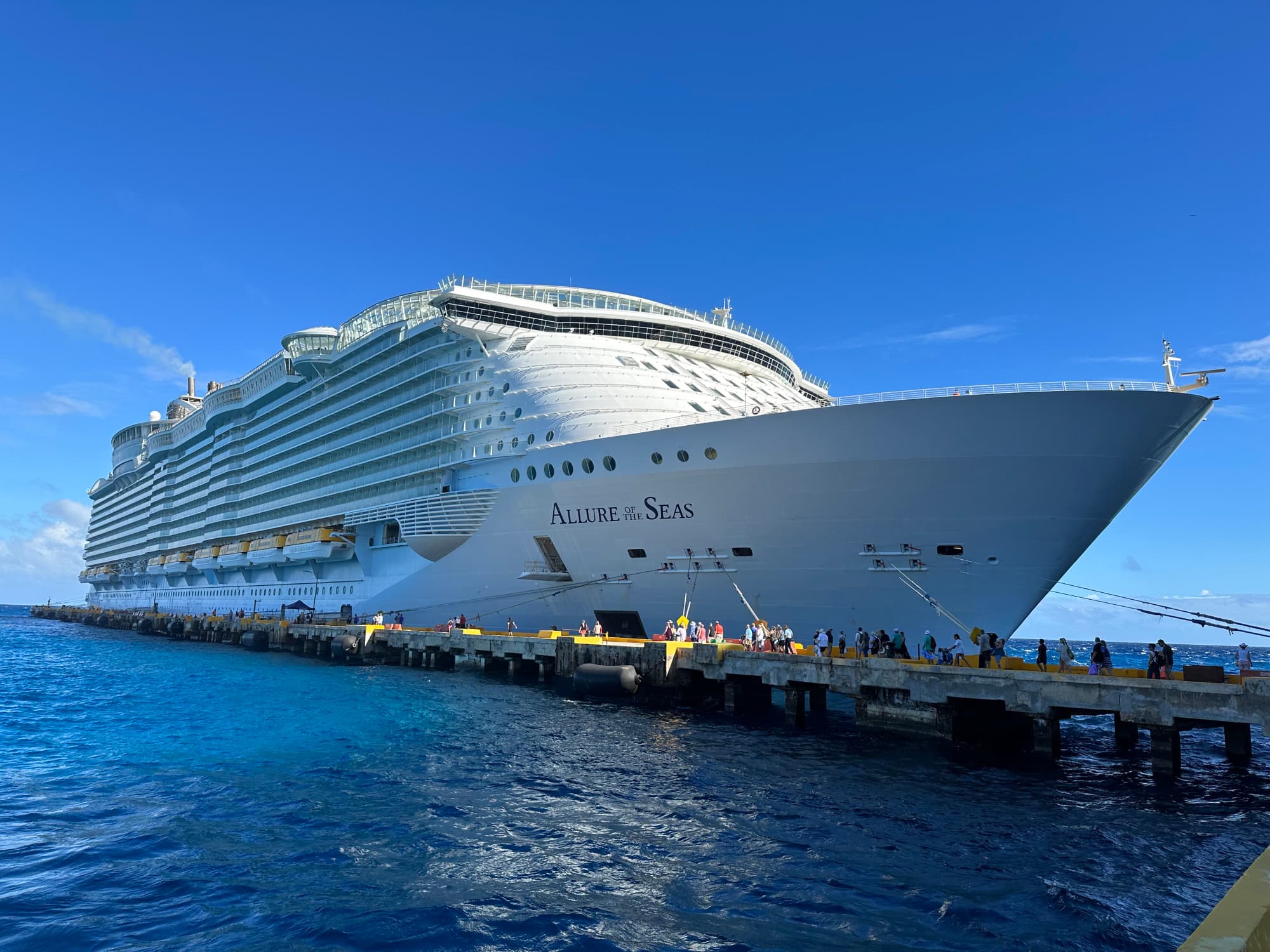 A white cruise ship docked in the water