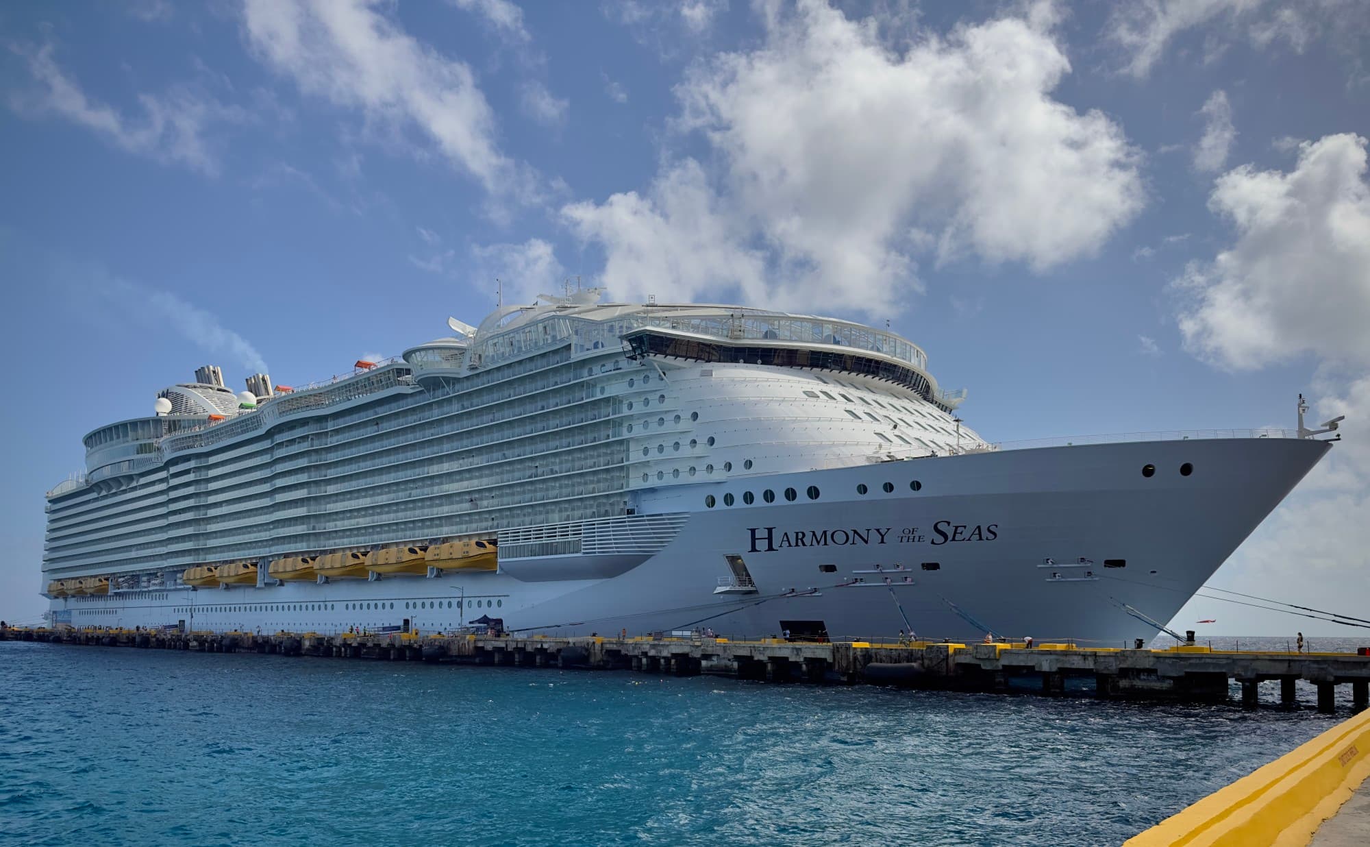 A large, white cruise ship docked in the water