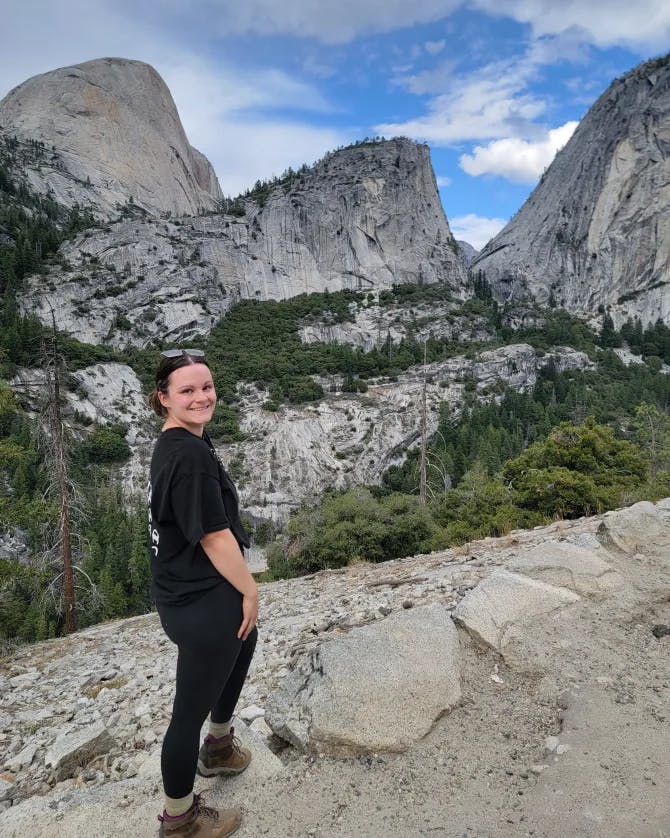 Picture of Ashlyn wearing black clothes and hiking boots at Clark Point