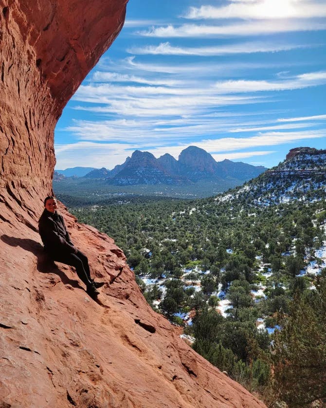 Picture of Ashlyn at Birthing Cave with views of the valley and mountains in the distance