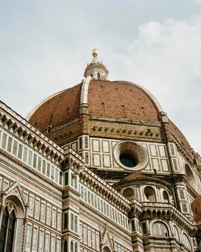 Low-angled view of an ornate building with a dome-shaped tower