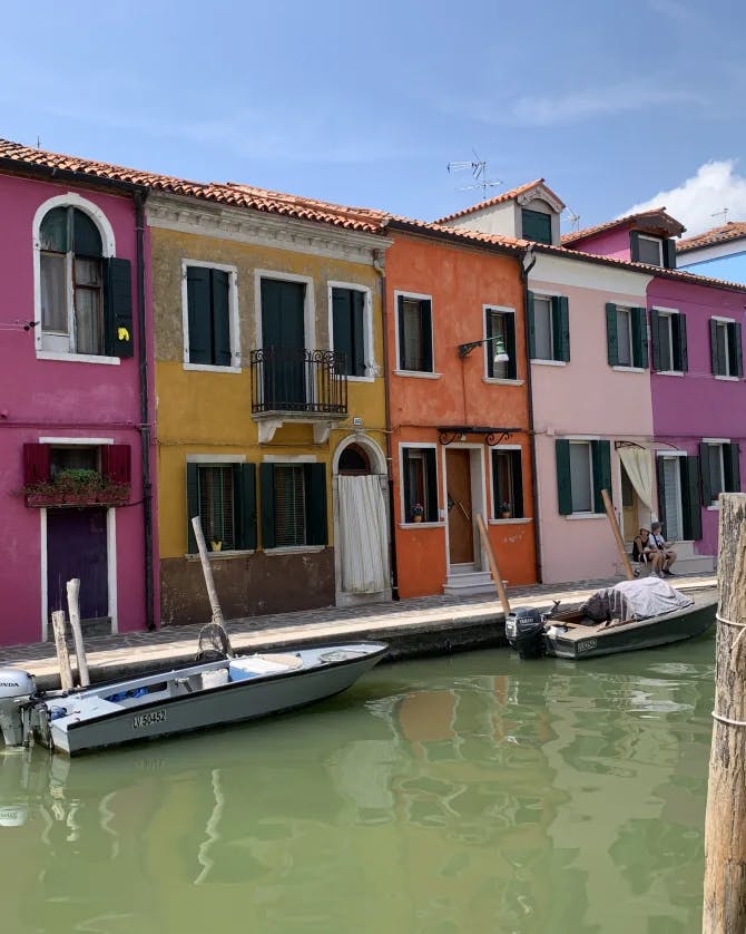 A photo of colorful row houses lining a canal