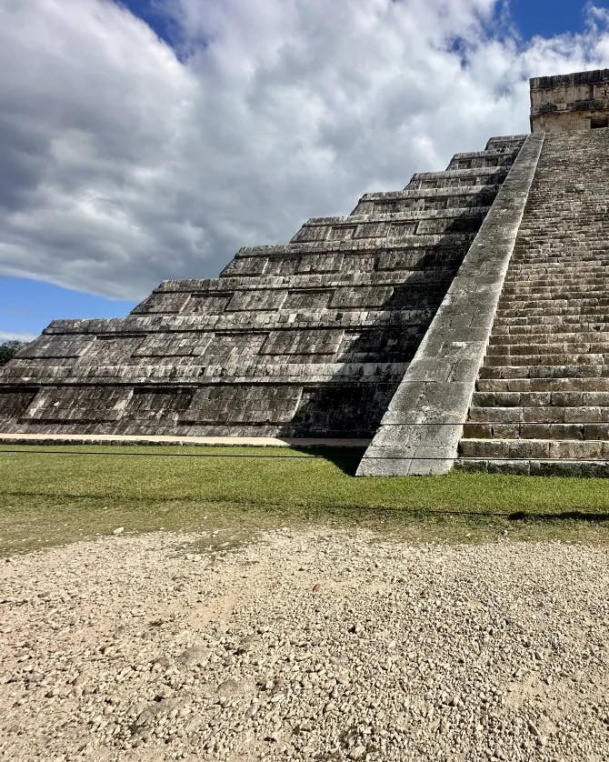 View of large stone pyramid with steep staircase carved into the pyramid