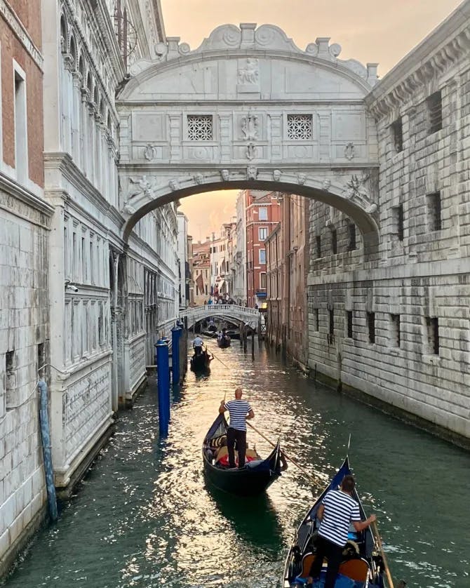 View of the The Bridge of Sighs with two gondolas below from a canal in Venice