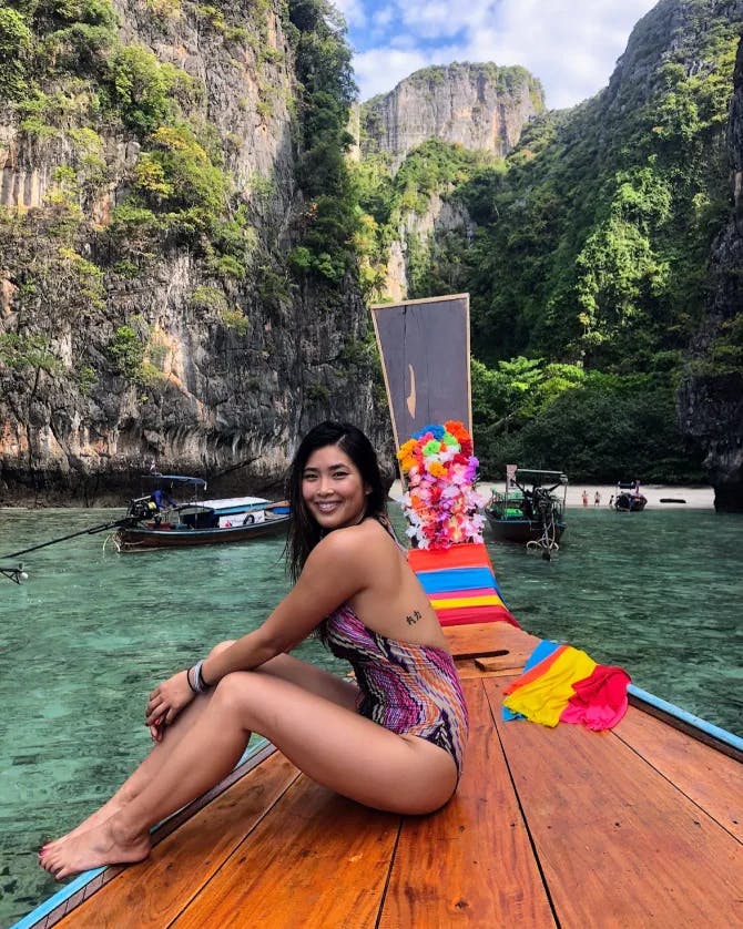 Advisor posing on a boat ride with colorful decorations on a sunny day. 