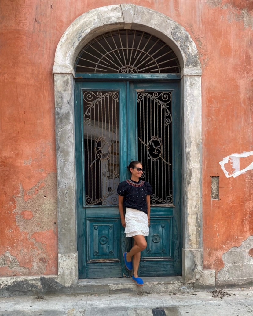 Travel Advisor Arlette Diederiks against an orange wall.