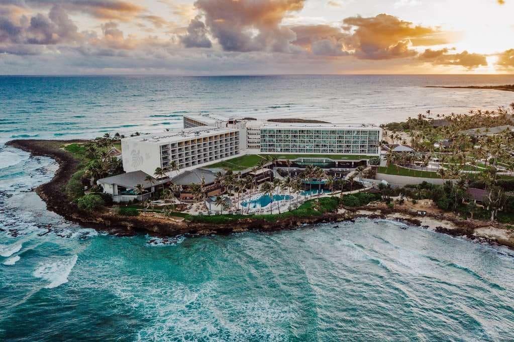 Turtle Bay Resort stands at the edge of a peninsula surrounded by turquoise water 