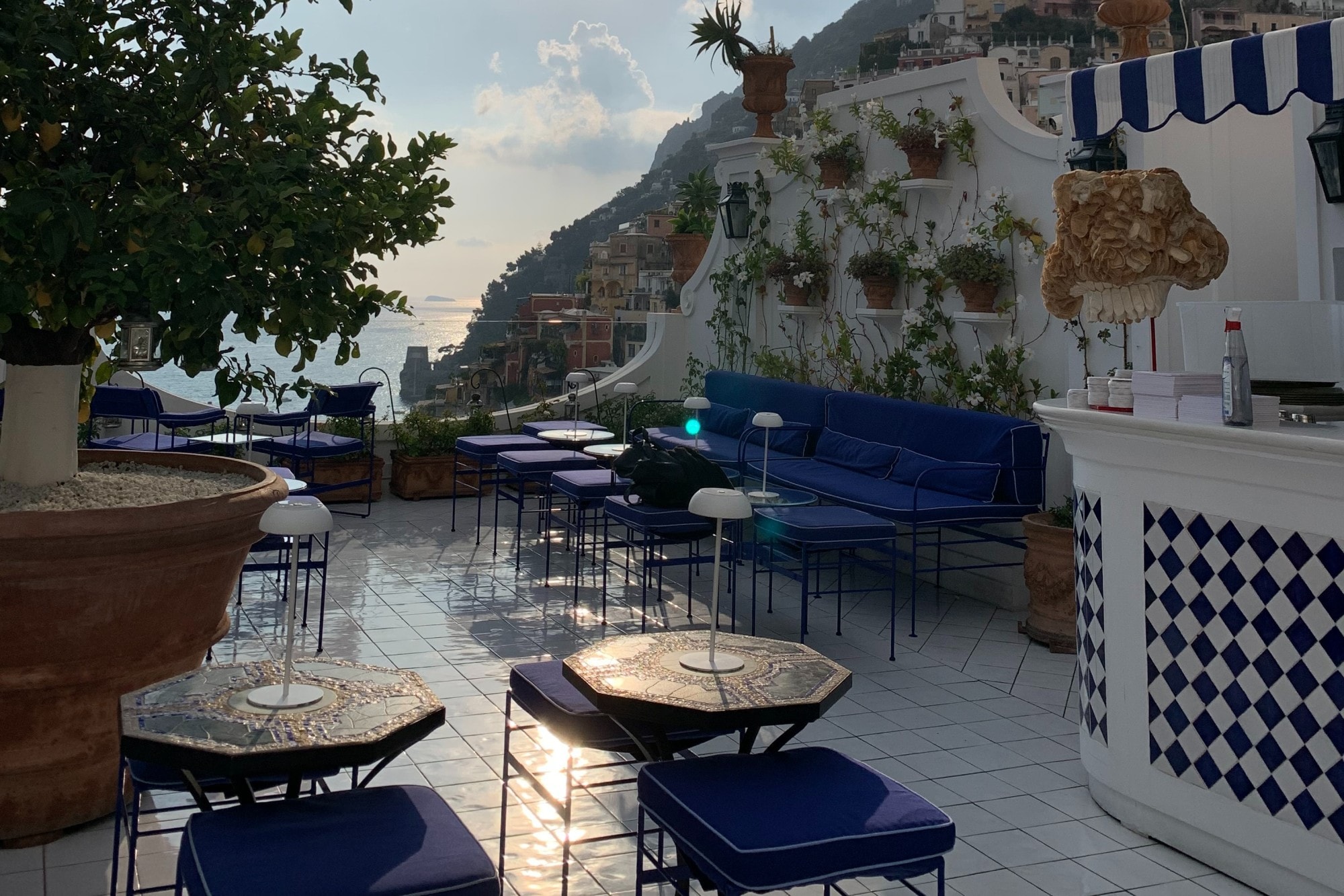 Bar with blue chairs on a terrace near coast. 