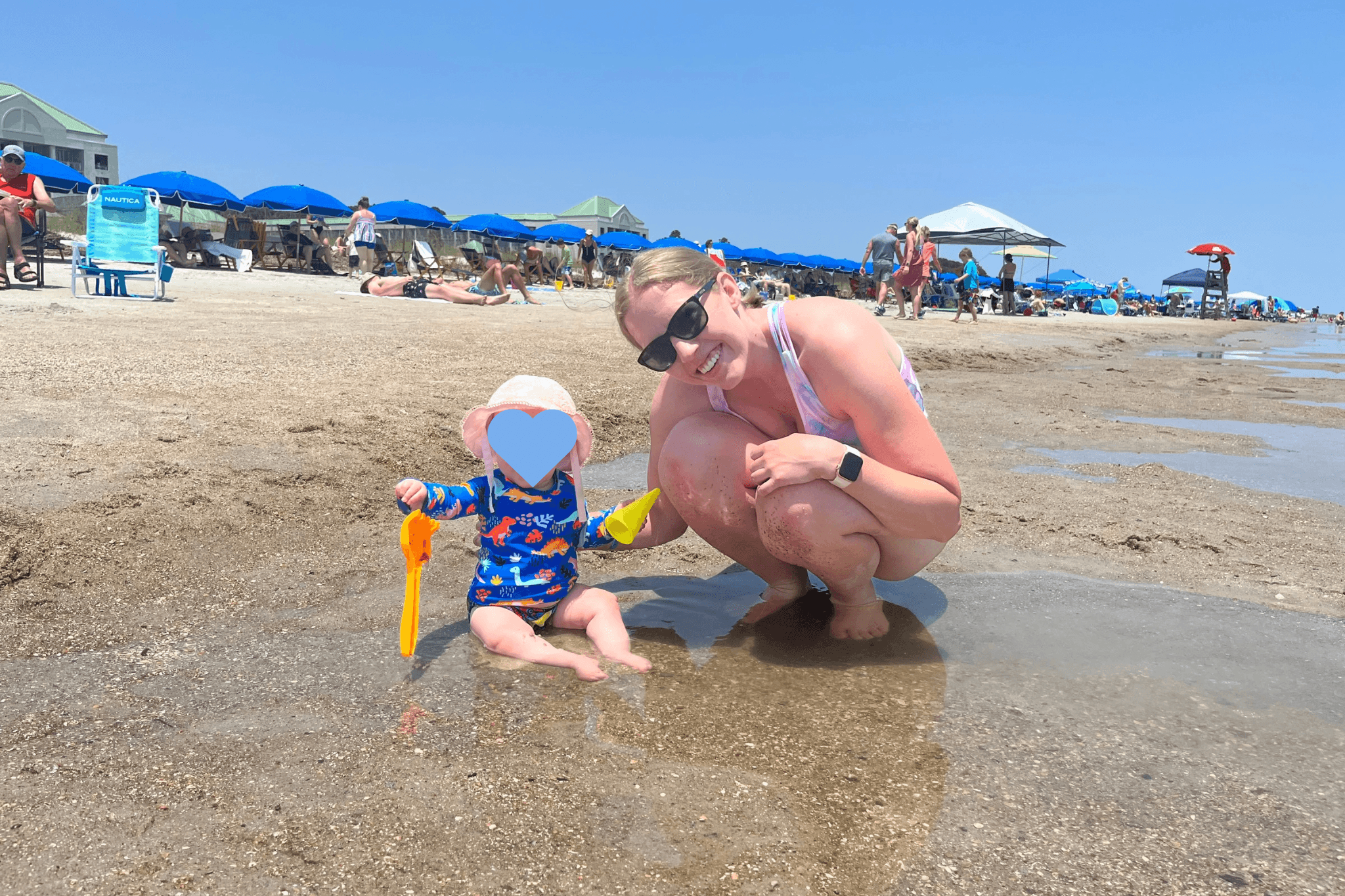 A mother and a baby on a beach during daytime