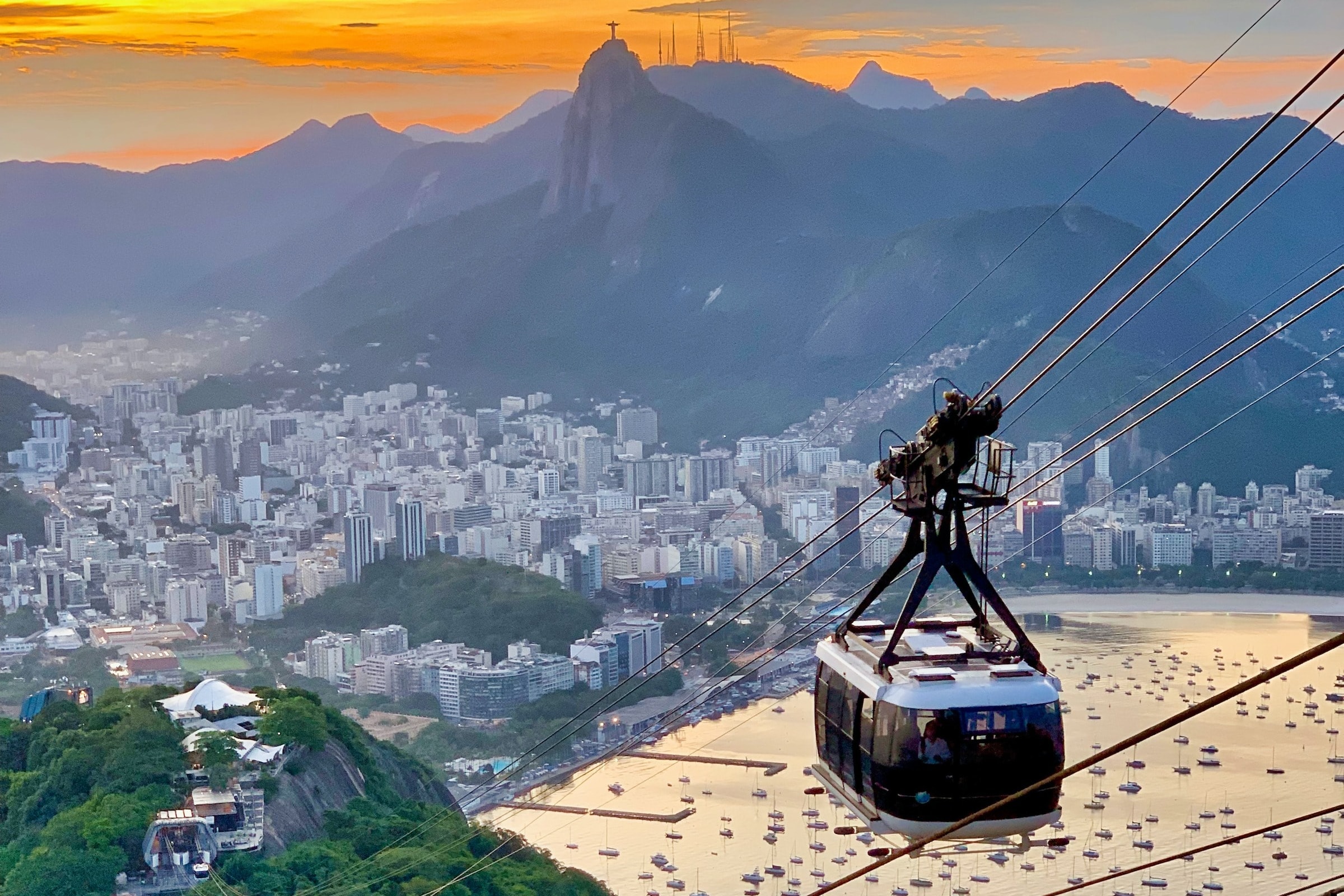 White cable car crossing on top of hills overlooking the city by the bay.