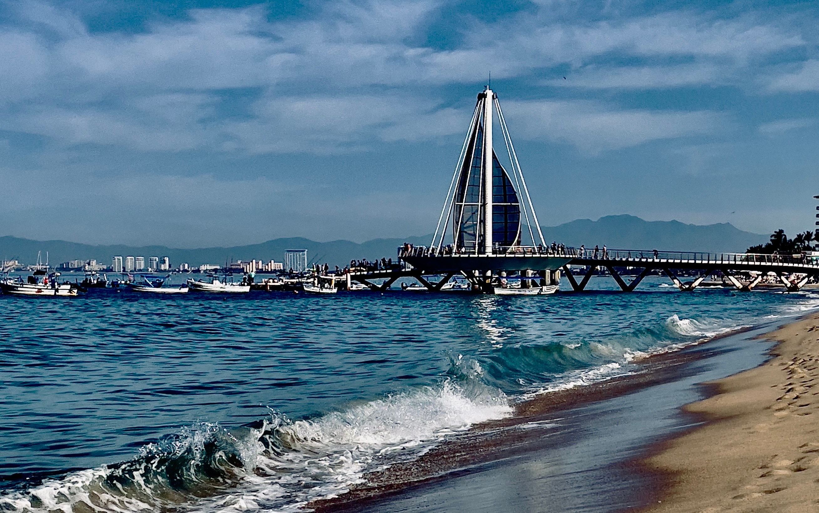 Waves crashing on Los Muertos Beach Pier