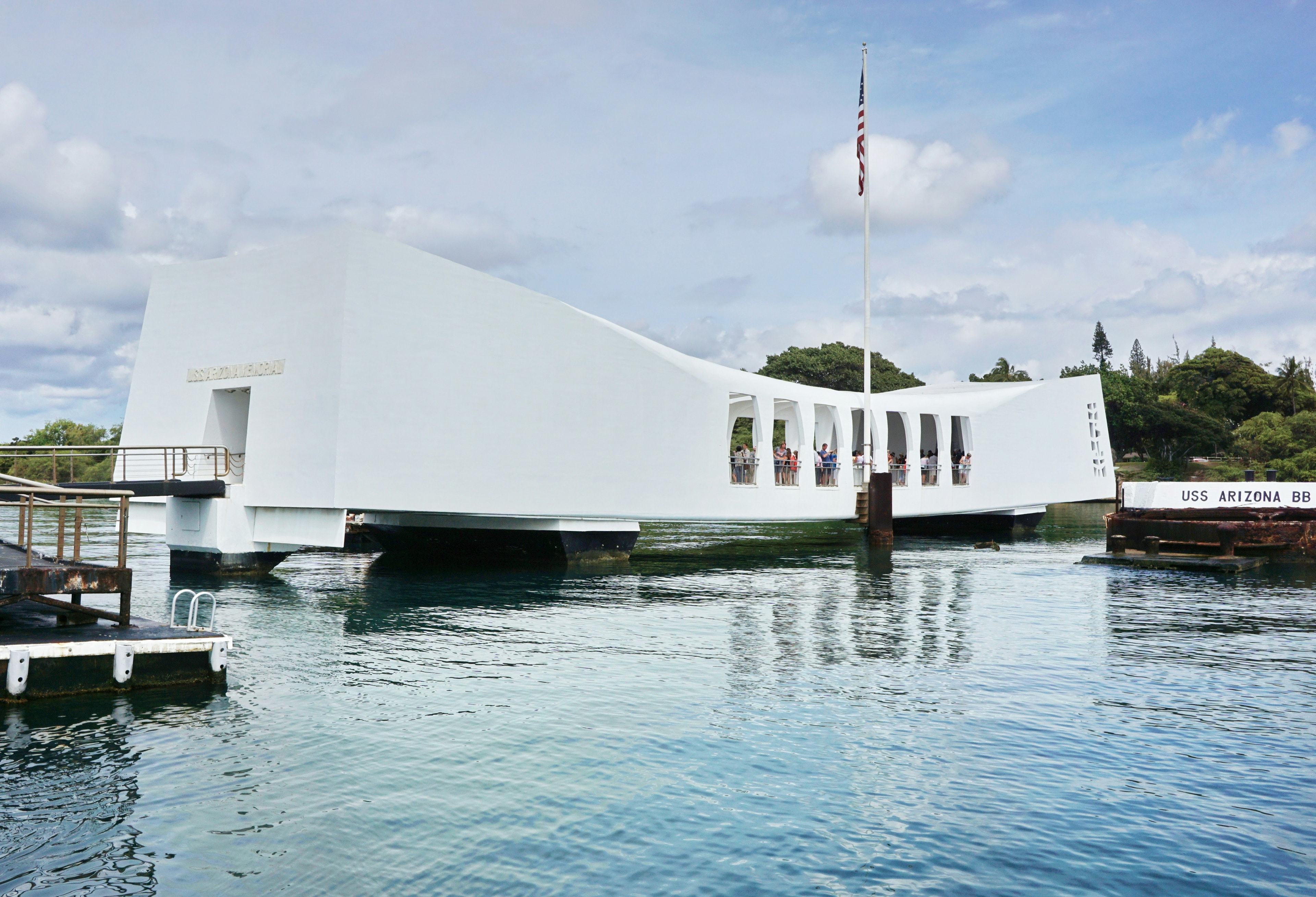 People in a white building on a body of water