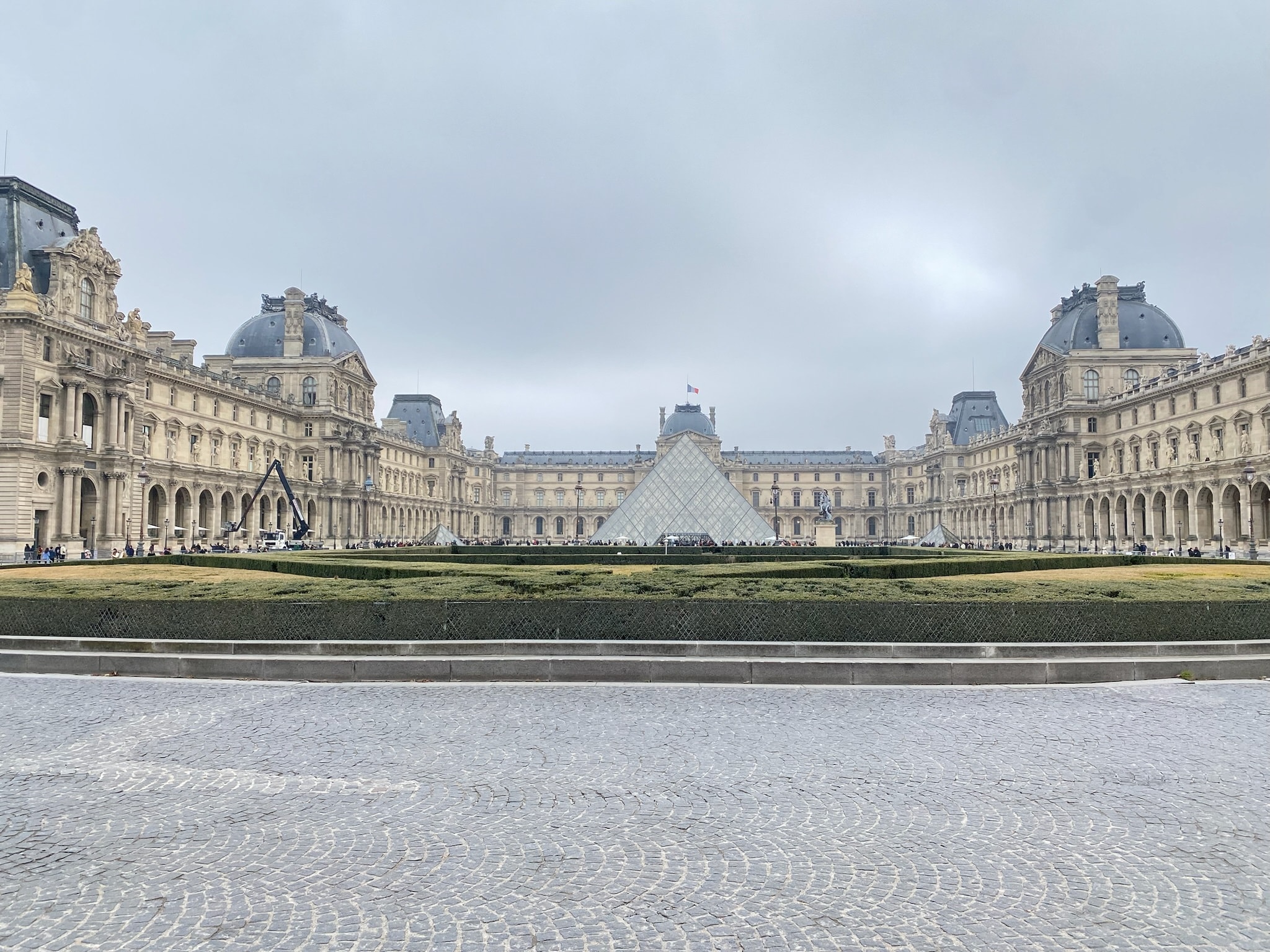 photo of Paris with the Louvre far in the distance with amazing gardens surrounding the area. 