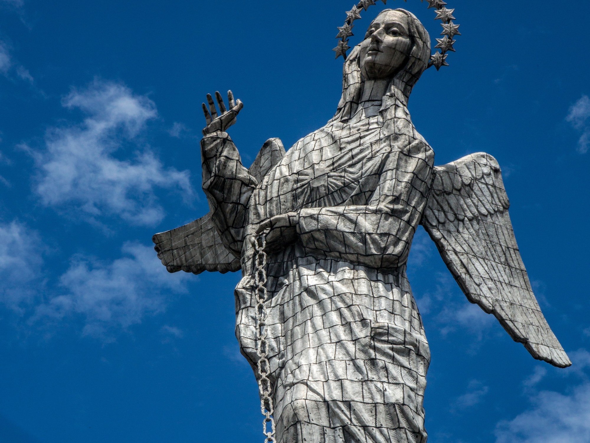 A grey statue of a woman.