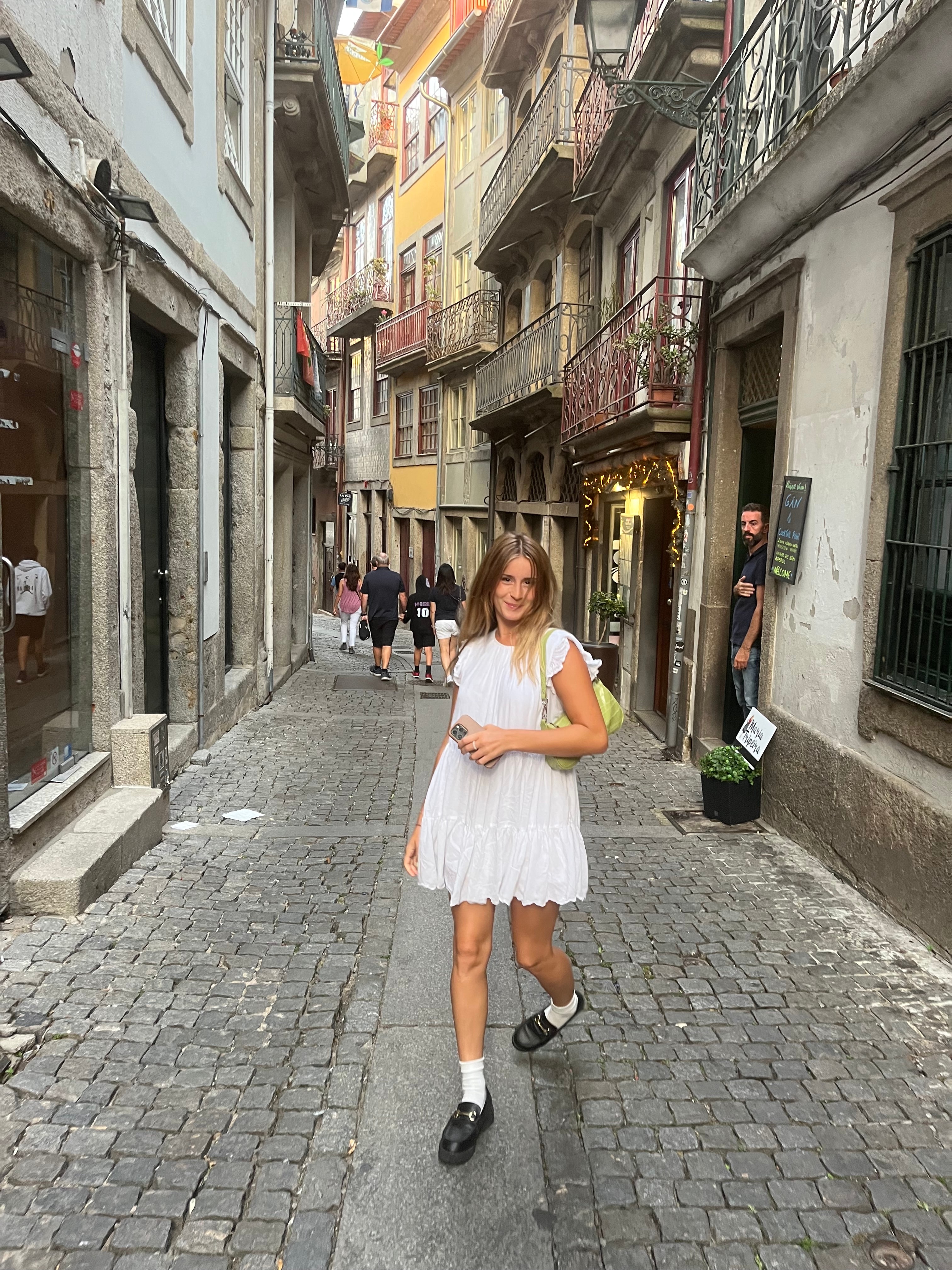 Woman posing in a white dress on the street