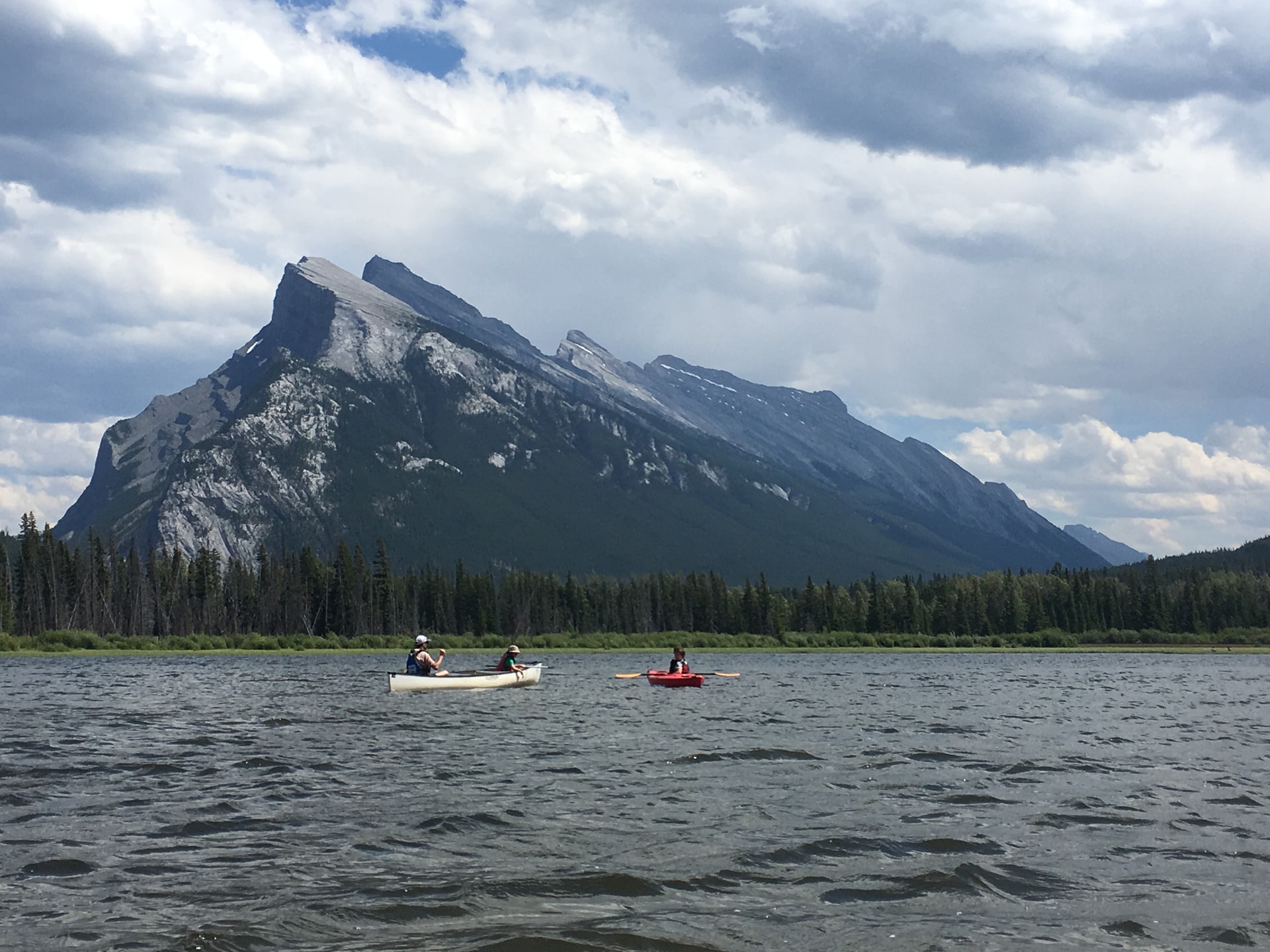 A beautiful view of Vermilion Lakes with two people canoeing 